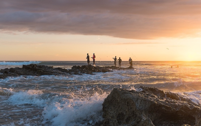 Fishermen on the rocks at sunset, Playa Santa Teresa